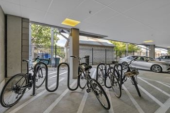 A row of bikes parked inside of a parking garage